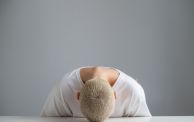 Rear View Of Man Relaxing Against Wall